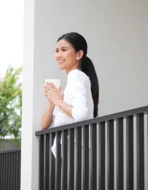 Resident taking in the view from a private balcony.