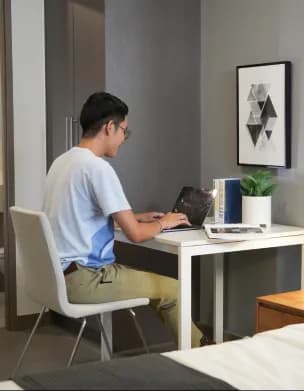 Resident working comfortably from a well-designed room.